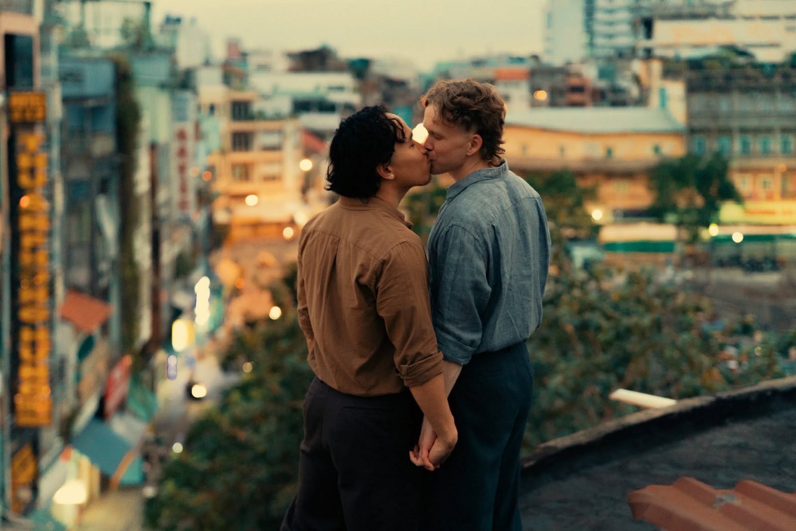 Pattrick & Ville sharing a kiss above the rooftops of Saigon
